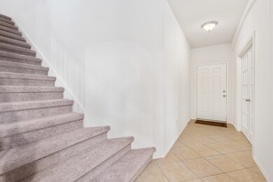 Entrance with office located to the left as you enter.  Notice the upgraded diagonal tile - it goes throughout the downstairs!