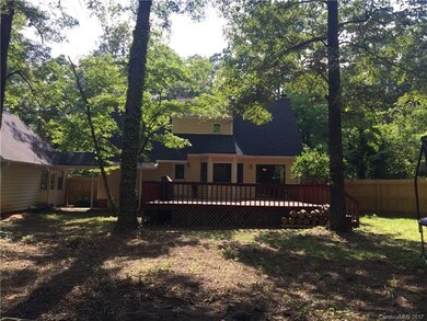 Rear of home has deck and lots of possibilities in