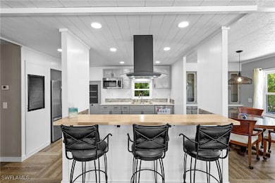 Kitchen with wooden counters, appliances with stai