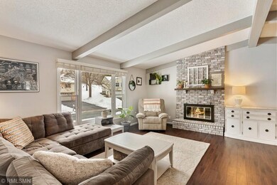 Spacious vaulted living room with wood fireplace