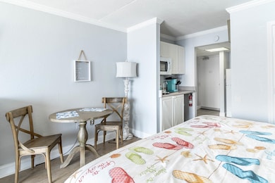 Bedroom featuring light wood-type flooring, crown 