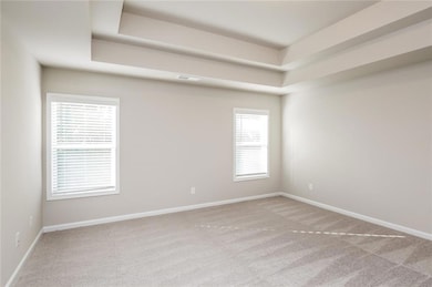 Empty room with carpet, visible vents, baseboards,