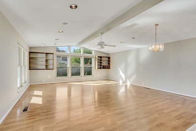 Unfurnished living room with light wood finished floors, a chandelier, ceiling fan, and recessed lighting