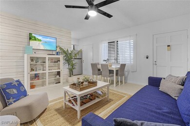 Tiled living room with ceiling fan, a textured cei