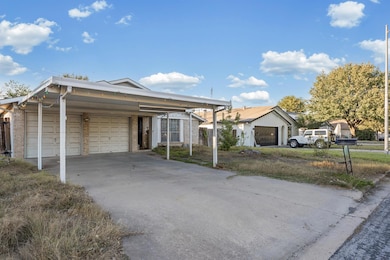 Ranch-style house featuring brick siding and a ga
