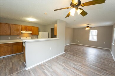 Kitchen with brown cabinets, light wood finished f