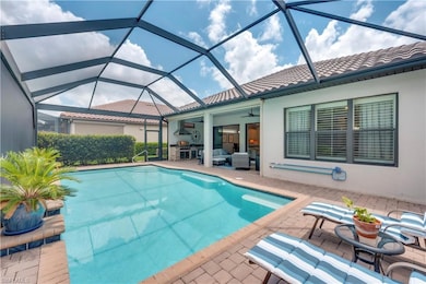 Outdoor pool featuring a patio, ceiling fan, and a lanai