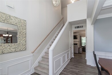 New laminate flooring on the first floor and wainscoting through entry and dining room
