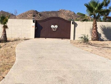 Block wall and front gate help to hide/protect the