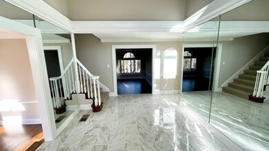 Foyer entrance with stairs, crown molding, baseboa