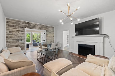 Living area featuring a fireplace and a chandelier