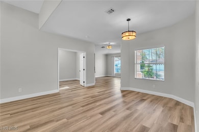 Large open floor plan with custom light fixtures throughout.
