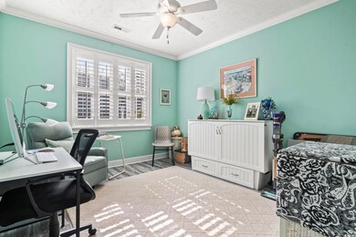 Bedroom with ornamental molding, hardwood / wood-s