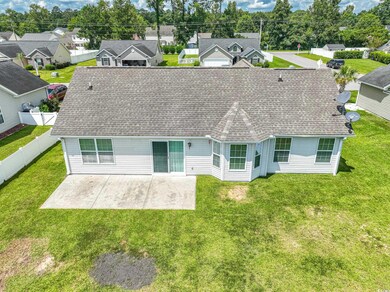 Rear view of property with a yard and a patio