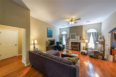 Living room featuring a high end fireplace, wood f