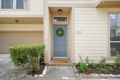 The front door greets you with a transom window above complemented by an overhead light for added charm and visibility.