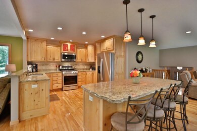 Large Granite Island with pendant lighting, lots o