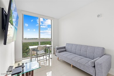 Living room with plenty of natural light and tile patterned flooring