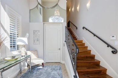 Staircase featuring a high ceiling and a elevator