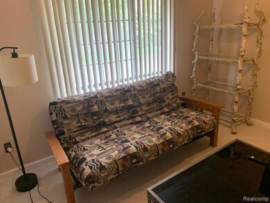 Sitting room with baseboards and carpet floors