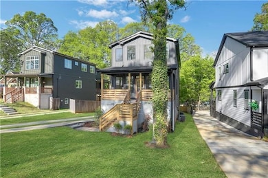 View of front of house with stairs, a front lawn, and board and batten siding