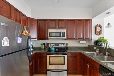 Kitchen featuring hanging light fixtures, applianc
