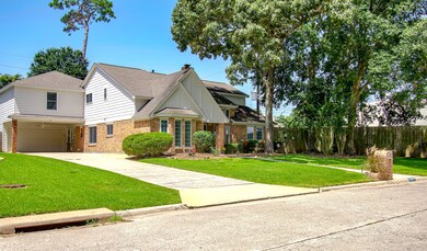 View of the side of the house featuring the 2 car garage and a workshop behind!
