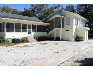Back of house with screened in porch and above the