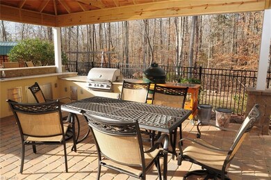 Outdoor living area with Kitchen, built-in Grill, Granite top cabinetry, refrigerator, sink