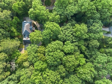 Aerial overview of property's location featuring a heavily wooded area