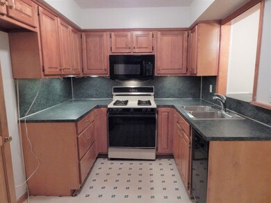 Kitchen features a gas stove, a new microwave and