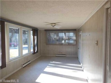 Den/Family/Great Room. Bright Den area has Pantry closet by kitchen and large closet area. E Could be used as Sunroom, Office or extra bedroom.