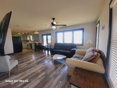 Living room featuring dark wood finished floors, 