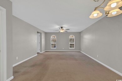 Carpeted spare room with ceiling fan with notable 