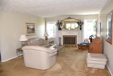 The fireplace is flanked by large windows for a li