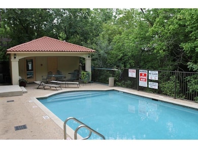 Community pool featuring a patio area, an outbuil
