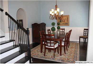 Formal dining room has a wall of windows that floo