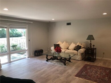 Spacious Living Room with wood look flooring and l