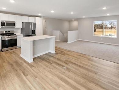 Open Layout. Photo taken of another home with similar plan and finishes. Photos and renderings may not depict actual plan, materials, & finishes may vary. All measurements are approximate.