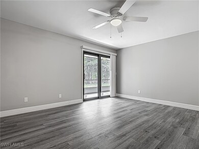 Unfurnished room with dark wood-type flooring, bas