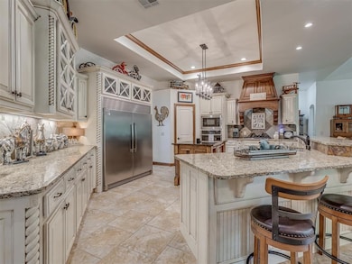 Gorgeous kitchen with oversized built-in refrigerator, ice maker, microwave, gas cooktop, walk-in pantry and eating bar.