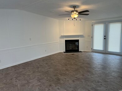 Unfurnished living room featuring a textured ceili