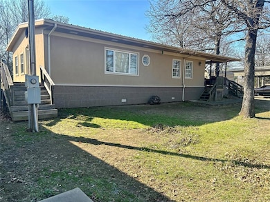 View of side of home featuring crawl space and a yard