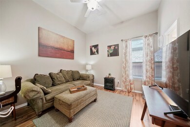 This bedroom is currently being used as a TV room. It also has a large closet, wood flooring, ceiling fan and attached bathroom.