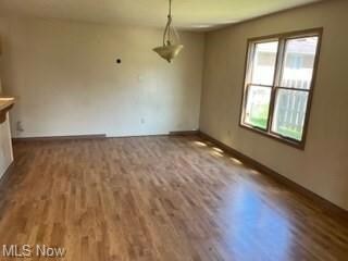 Spare room featuring hardwood flooring