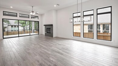 Unfurnished living room with a ceiling fan, a gla