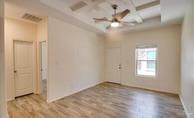 Unfurnished room with coffered ceiling, a high ceiling, ceiling fan, and light wood-type flooring