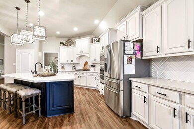 Upgrade white kitchen cabinetry adds a clean rich look. Notice the darker color center Island to give accent color to this beautiful modern kitchen