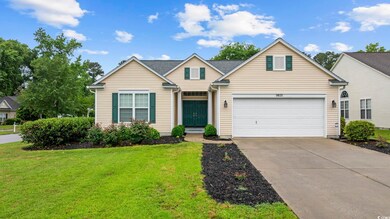 Traditional home featuring concrete driveway and a