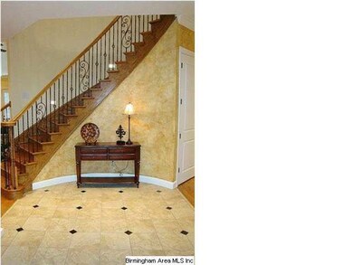 The curved, open staircase adds to the impressive 